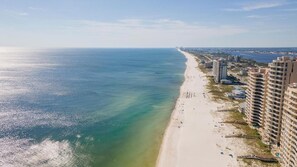 A coastal cityscape with a beach, high-rise buildings, and a clear view of the ocean. - Cozy & Bright Townhome w/EV Charger-Walk to Beach (Perdido Key)