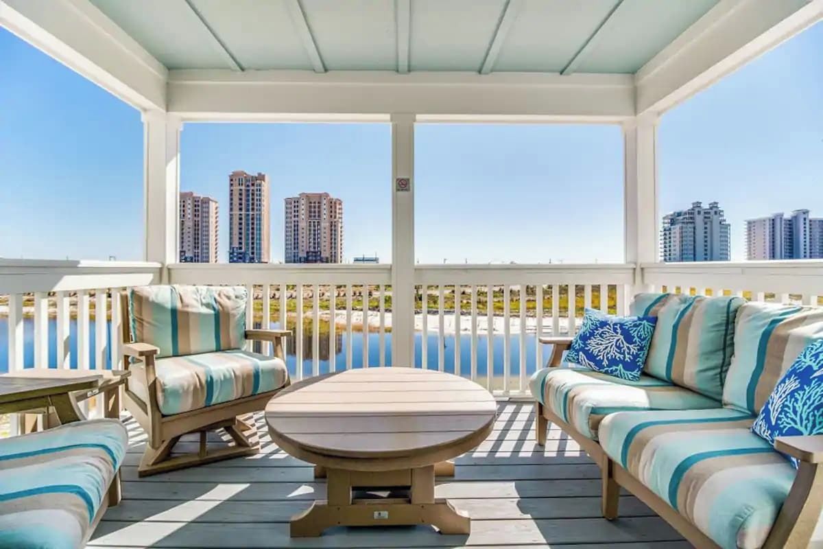 A covered outdoor seating area with a view of high-rise buildings.