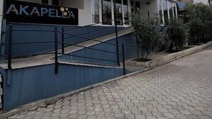 A building with a sign reading "AKAPELON" and a staircase leading to the entrance. - Akapella (Denizli)