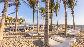 Private beach, white sand, sun loungers, beach umbrellas