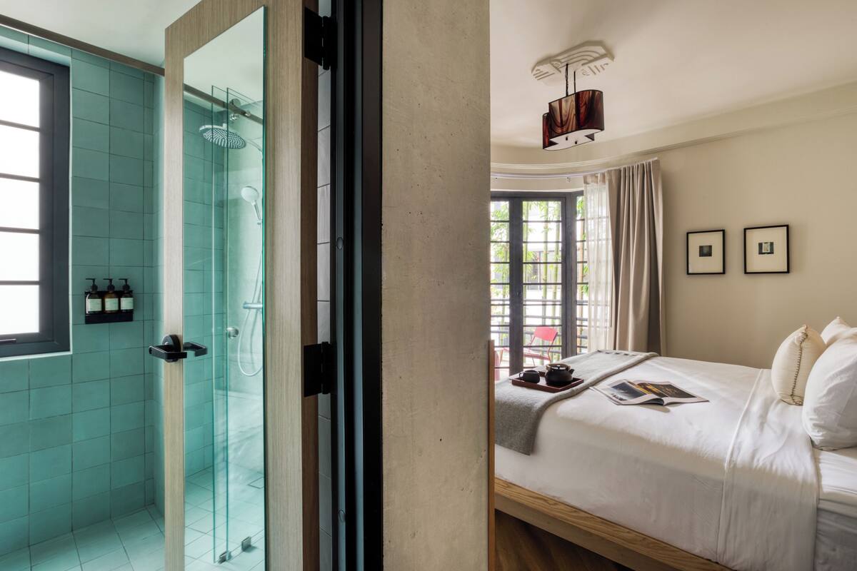 A modern bathroom with a glass shower enclosure and a visible toilet.