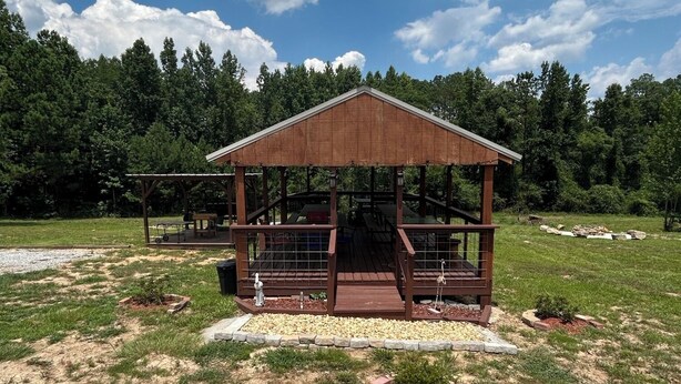 A wooden gazebo with a metal roof, surrounded by a grassy field and trees. - Charming cottage with AC, Pet-friendly, 4 guests, 3 miles from West Point Lake
(Five Points)