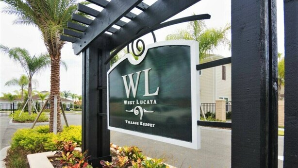 A sign for West Lucaya Village Resort with a pergola structure and landscaped garden. - Beautiful Townhouse Next to Disney Parks 24 (Kissimmee)