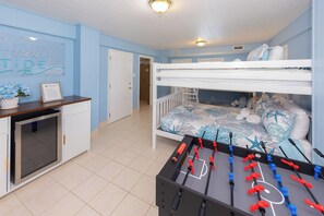 A room with a bunk bed, a foosball table, and a kitchenette. - Hebb Tide- 5 Bd. Semi OF- Direct Bch Access, Pool, Dog Friendly (Virginia Beach)
