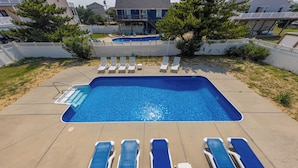 A rectangular swimming pool with a clear blue water surface, surrounded by a concrete deck. - Hebb Tide- 5 Bd. Semi OF- Direct Bch Access, Pool, Dog Friendly (Virginia Beach)