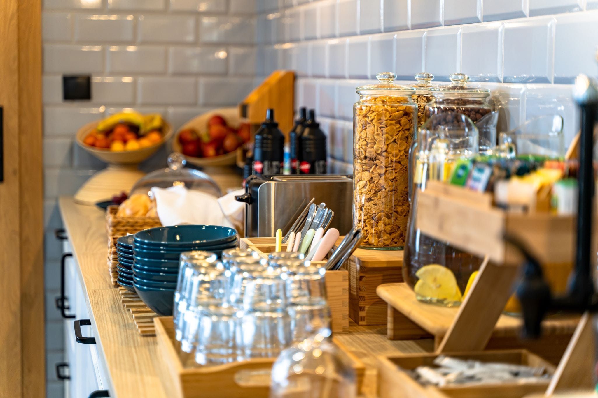 A buffet setup with various food items and utensils.
