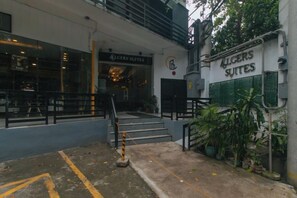 Entrada de hotel con dos suites identificadas como 'Rogers Suites' y 'Kugers Suites', con una escalera que lleva a la entrada.