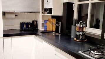 Family Townhome, 2 Bedrooms | Private kitchen | Full-size fridge, microwave, oven, stovetop