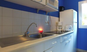 A kitchen with a stainless steel sink, a microwave, a coffee maker, and a toaster. - Vvf Villages Piriac Sur Mer (Piriac-sur-Mer)