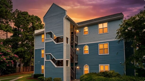 A two-story building with a unique architectural design, featuring a central staircase and multiple windows.