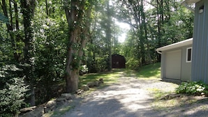 A gravel path leading to a rustic cabin surrounded by dense trees. - The Cottage in the Woods, near Deersville and Tappan and Clendening Lakes (Deersville)