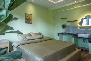 A bedroom with a bed, a nightstand, a wall-mounted shelf with a plant, a mirror, and a window. - Ben Thanh Homestay And Apartment (Ho Chi Minh Municipality)