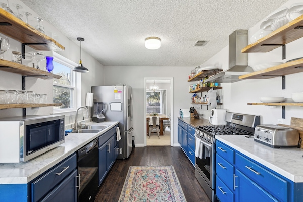 Kitchen with microwave, toaster, blender, and double sink