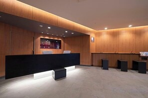 A reception area with a reception desk, a TV screen, and a trash bin. - Washington R&B Hotel Sendai Higashiguchi (Sendai)