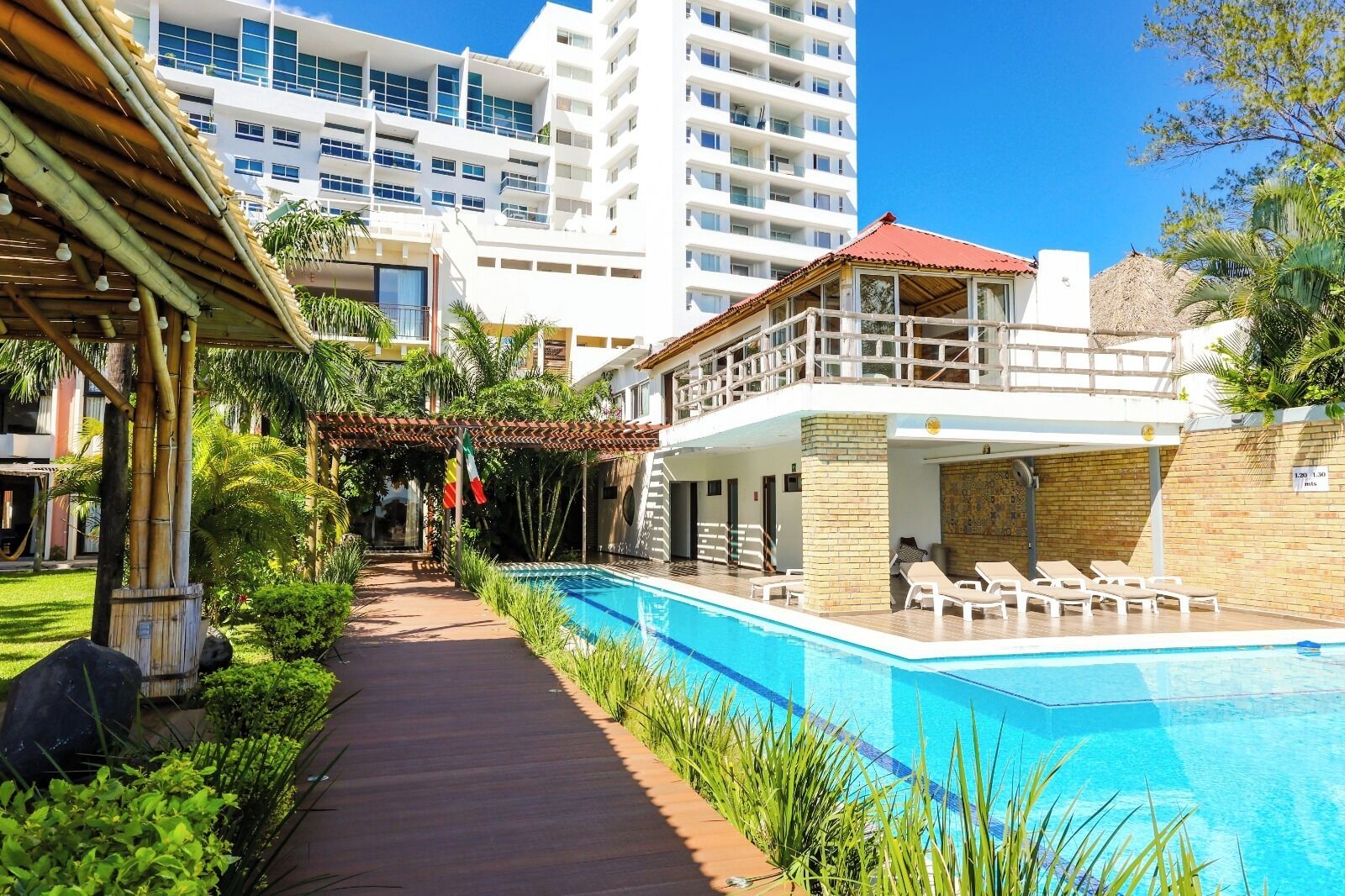 Alberca al aire libre, sombrillas en la alberca y camastros 