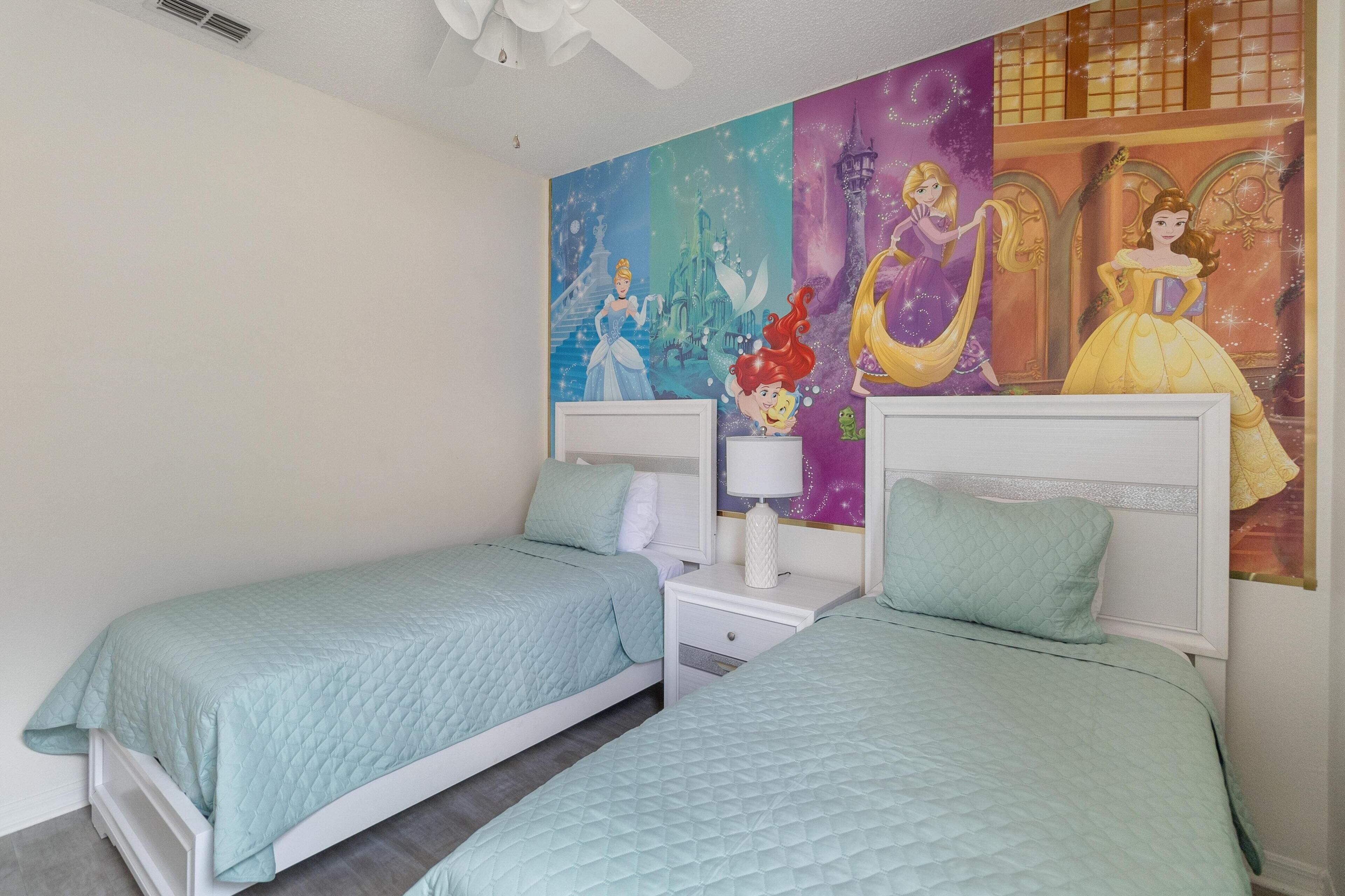 Een slaapkamer met twee bedden, een nachtkastje en een muurschildering.