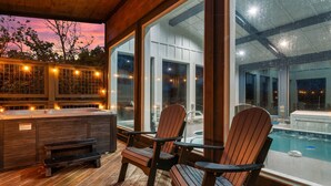 An outdoor deck with wooden chairs and a hot tub, overlooking a swimming pool. - Free Dollywood Tix/Indoor Heated Pool/A+Views/ (Sevierville)