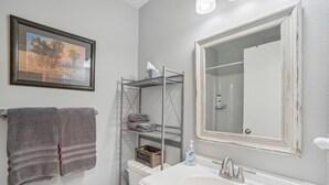 A bathroom with a large mirror, a sink, and a towel rack. - Comfortable Studio in the Heart of Park City (Park City)