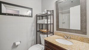 A bathroom with a sink, mirror, towel rack, and toilet. - Comfortable Studio in Park City 325 (Park City)