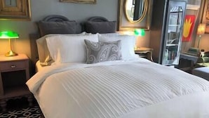 A neatly made bed with white linens, two pillows, and a patterned throw. - Private Detached Cottage ~Near Downtown Phoenix! (Phoenix)