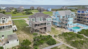 A coastal residential area with houses featuring balconies and a swimming pool. - 7865- Peridot, Oceanfront 5 bedroom home in Frisco! (Frisco)