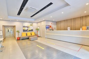 A modern reception area with a sofa, a reception desk, and a TV screen. - Taishangdeng Hotel (Beijing Daxing Huangyi Road Public Security University Branch) (Beijing)