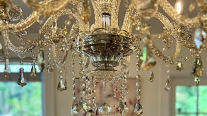 A chandelier with multiple crystal pendants hanging from a central structure.