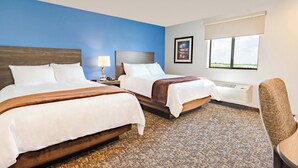 A hotel room with two beds, a nightstand, a lamp, a framed picture, a window with a view, and a chair. - Cozy 2 queen hotel in delightful Huntersville up to 4 people (Huntersville)