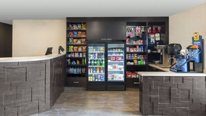 A self-service kiosk area with refrigerated beverage dispensers, snack shelves, and a coffee machine. - Cozy 2 queen hotel in delightful Huntersville up to 4 people (Huntersville)