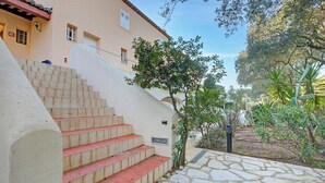 A set of stone steps leading up to a building with a tiled roof and a small tree beside it. - Studio Pinet - Near St Tropez - Pool, Ramatuelle, France (Ramatuelle)