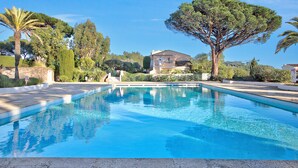 A swimming pool with a house in the background. - Studio Pinet - Near St Tropez - Pool, Ramatuelle, France (Ramatuelle)
