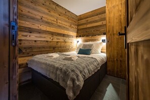 Cozy bedroom with a single bed, white comforter, and a blue accent pillow.