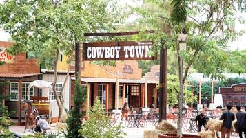 A rustic building with a sign reading "Cowboy Town."