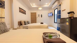A hotel room with two beds, a refrigerator, a TV, and a window. - Talay Pool Villa (Pattaya)