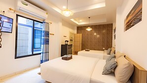 A modern hotel room with a large bed, a small desk, a wardrobe, and a view of the outside. - Talay Pool Villa (Pattaya)