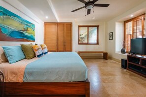 A bedroom with a bed, wooden wardrobe, a ceiling fan, a television, and a window with blinds. - Best Views of Zihua 3Bed 3 Bath luxury (Zihuatanejo)