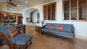 A spacious living area with a sofa, chairs, and a dining table. - Best Views of Zihua 3Bed 3 Bath luxury (Zihuatanejo)
