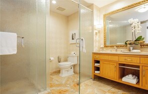 A bathroom with a glass shower enclosure, a toilet, a sink with a mirror, and a vanity with a towel rack. - Executive-style stay at Trump International in Las Vegas (Las Vegas)