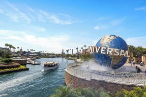 A water body with a boat, a large globe with 'UNIVERSAL' text, and a bridge with decorative railings. - Vor4632td: 7 Bed, Bricktopia, Petting Zoo, Gaming Nook (Orlando)