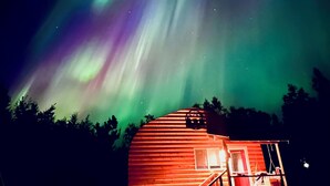 A wooden cabin with a red roof, a porch, and a window. - Cozy Big Lake Cabin + Private Spa House, Hot Tub & Sauna (Wasilla)