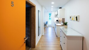 A modern kitchen with white cabinets, a wooden countertop, and a potted plant. - Modernes Apartment mit Terrasse am Klopeiner See (Unterburg am Klopeiner See)