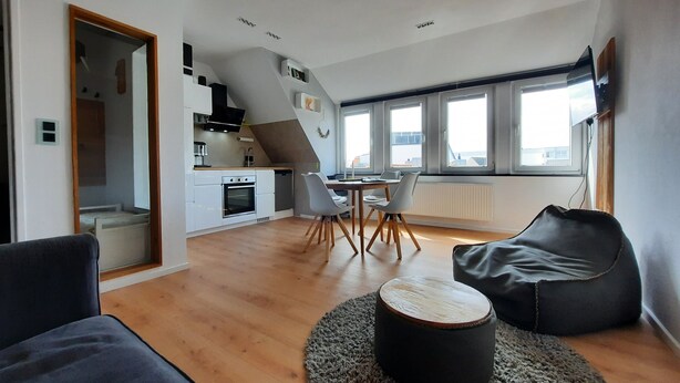 Eine moderne Wohnung mit Küche, Essbereich und Wohnraum.