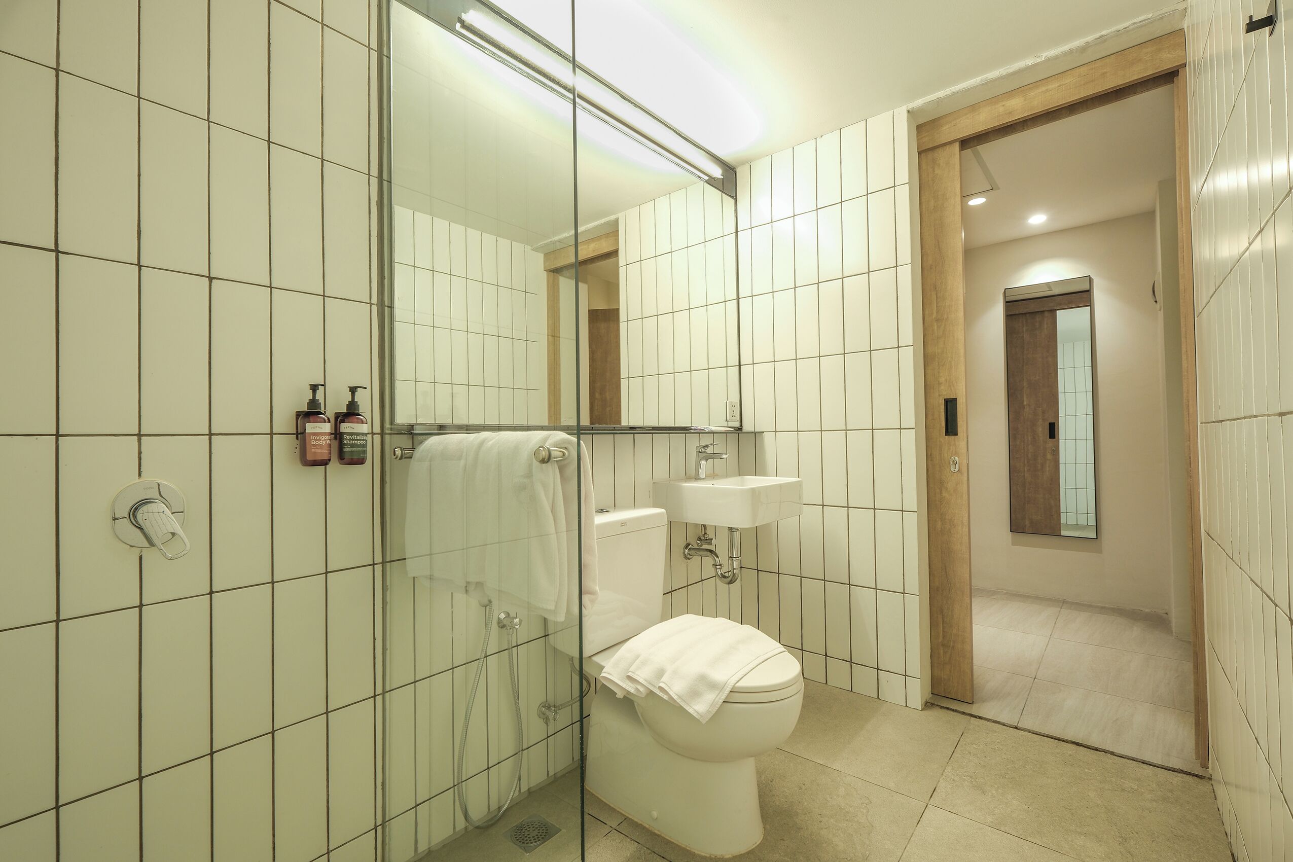 A bathroom with a toilet, sink, and shower area.