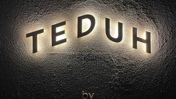 A textured surface with the word "TEDUH" illuminated in the center and "by PARK 5" at the bottom.