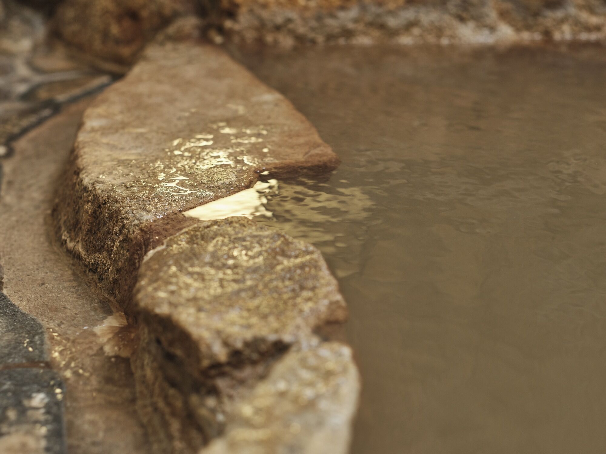 A close-up of a stone structure with water.