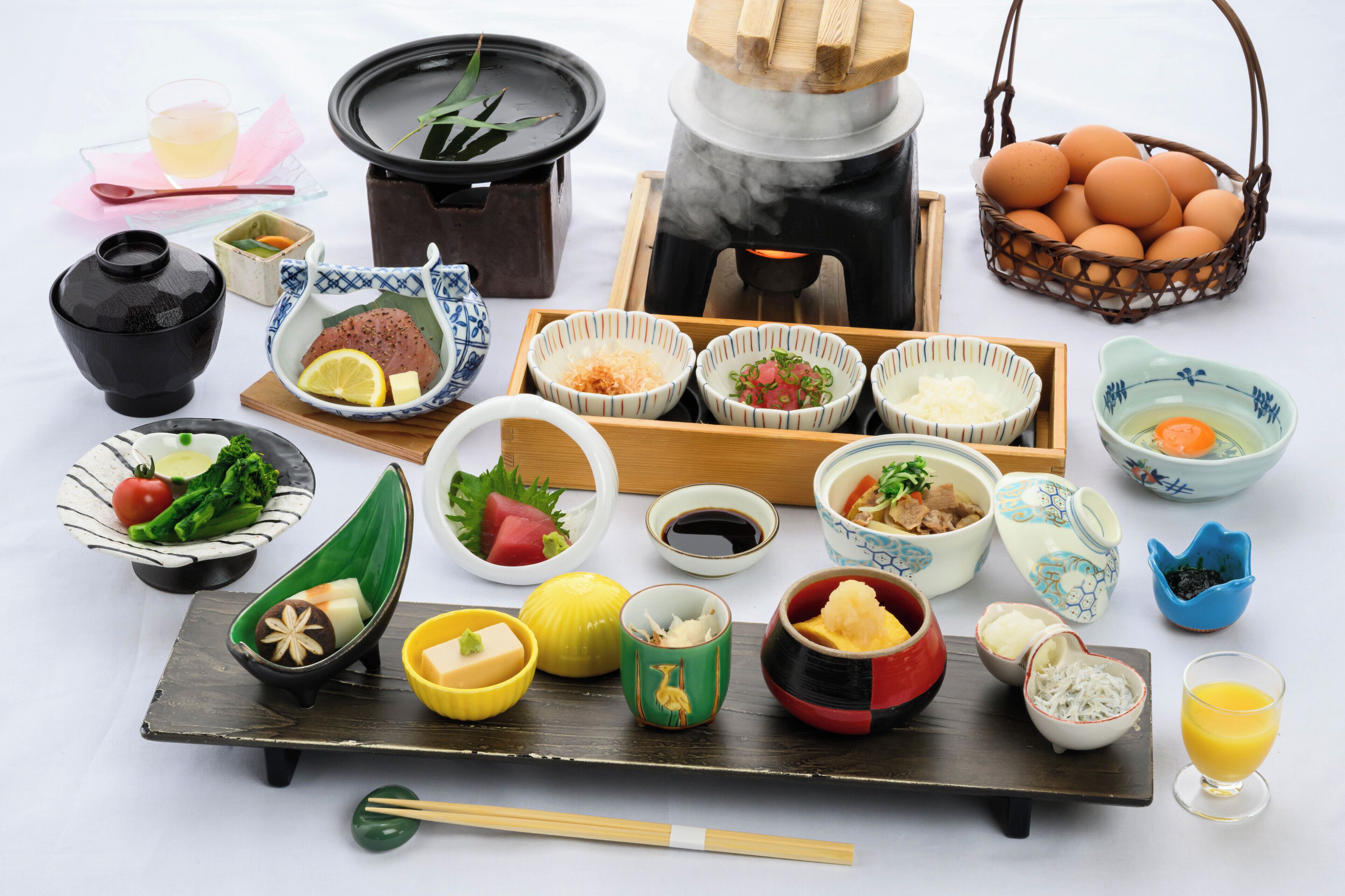 A variety of Japanese dishes and utensils arranged on a table.