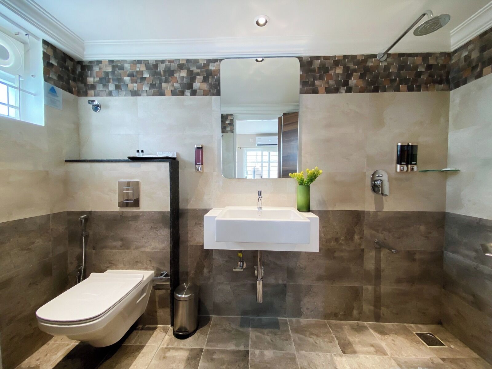 A modern bathroom with a toilet, sink, and shower.
