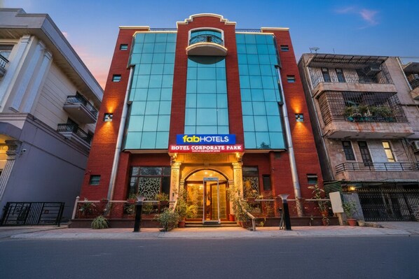 A modern hotel building with a prominent sign reading "FahHotels Hotel Corporate Park".