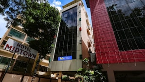 A hotel building with a sign for 'HOTEL MIDTOWN' and 'fabHOTELS'. - Fabhotel Fortune Begumpet (Hyderabad)