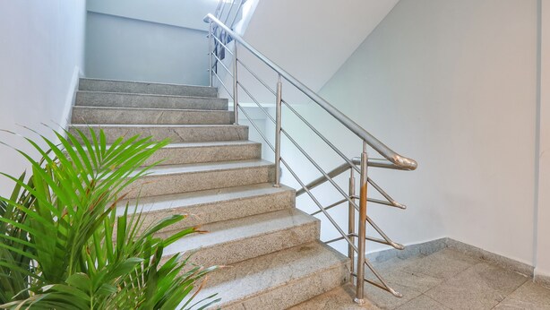 A staircase with metal railings and stone steps, leading to an upper floor. - Fabhotel Fortune Begumpet (Hyderabad)